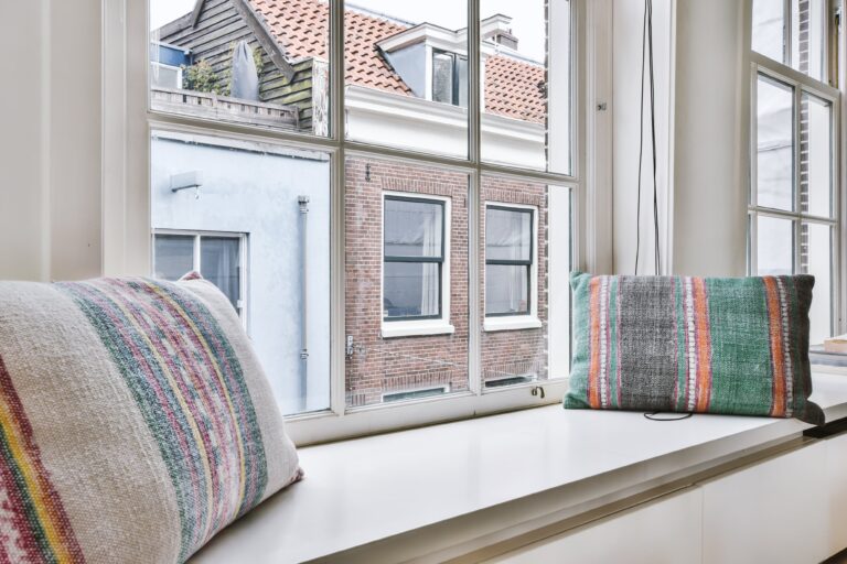cushions-on-windowsill-near-window-2021-10-21-02-43-41-utc-min